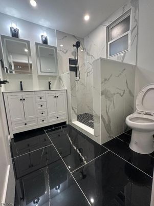 Bathroom, Dual Sink Vanities, Glass Shower, Interior, Marble Walls, Recessed Lighting