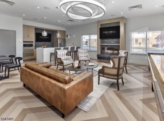 Dining room, Fireplace, Interior, Kitchen, Living room, Pendant Lights, Recessed Lighting, Stainless Steel Appliances, Wood Texture Flooring