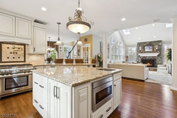 Fireplace, Interior, Kitchen, Living room, Pendant Lights, Recessed Lighting, Stainless Steel Appliances, Wood Texture Flooring