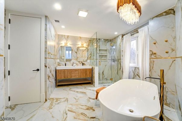Bathroom, Chandelier, Dual Sink Vanities, Free Standing Baths, Glass Shower, Interior, Marble, Marble Walls, Recessed Lighting
