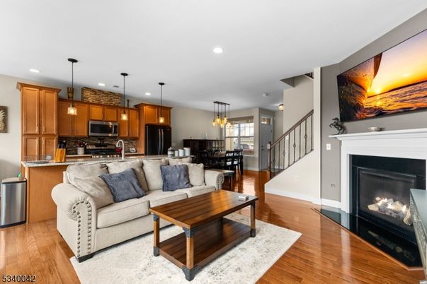 Dining room, Fireplace, Interior, Kitchen, Living room, Pendant Lights, Recessed Lighting, Stainless Steel Appliances, Wood Texture Flooring