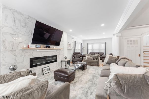 Fireplace, Interior, Living room, Marble Walls, Recessed Lighting, Wood Texture Flooring