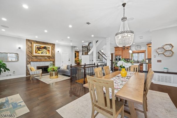 Chandelier, Dining room, Fireplace, Interior, Kitchen, Living room, Pendant Lights, Recessed Lighting, Stainless Steel Appliances, Wood Texture Flooring