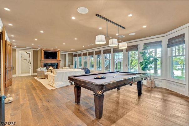 Billiard Table, Fireplace, Game Room, Interior, Living room, Pendant Lights, Recessed Lighting, Wood Texture Flooring