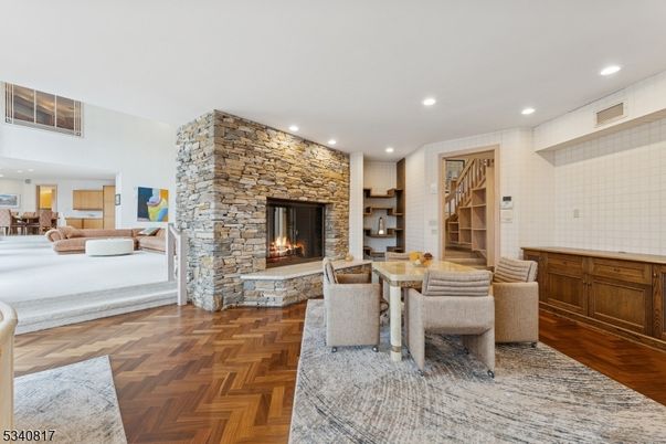 Dining room, Fireplace, Interior, Living room, Recessed Lighting, Stone Walls, Wood Texture Flooring