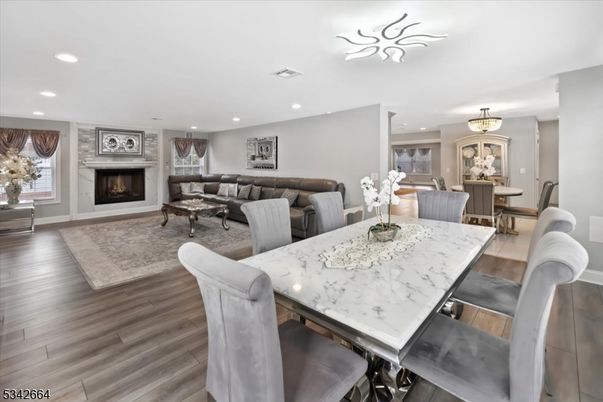 Dining room, Fireplace, Interior, Living room, Recessed Lighting, Wood Texture Flooring