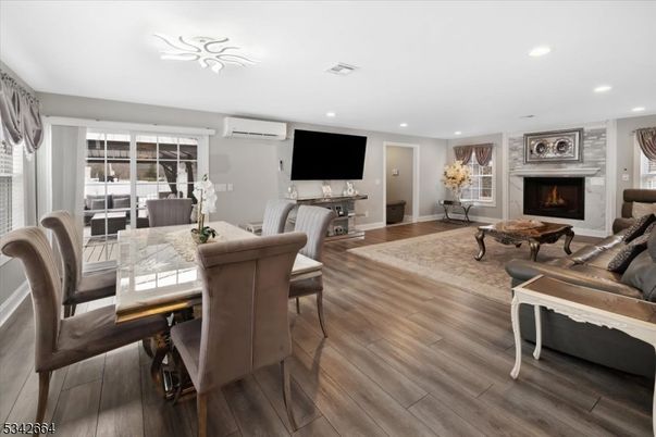 Dining room, Fireplace, Interior, Living room, Recessed Lighting, Wood Texture Flooring