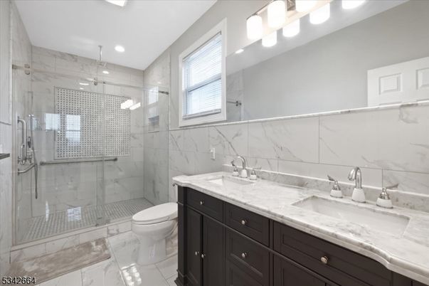 Bathroom, Dual Sink Vanities, Glass Shower, Interior, Marble, Marble Walls, Recessed Lighting