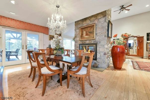 Chandelier, Dining room, Fireplace, Interior, Recessed Lighting, Stone Walls, Wood Texture Flooring