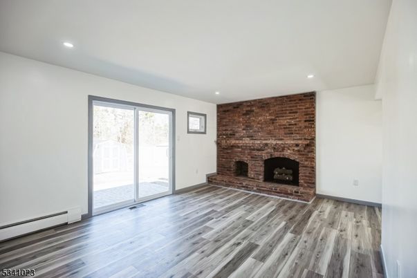 Empty room, Fireplace, Interior, Recessed Lighting, Stone Walls, Wood Texture Flooring
