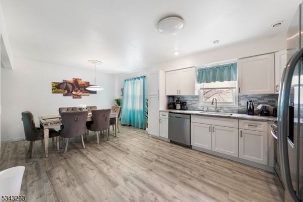 Dining room, Interior, Kitchen, Pendant Lights, Recessed Lighting, Stainless Steel Appliances, Wood Texture Flooring