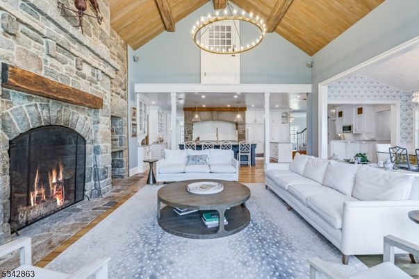Chandelier, Fireplace, Interior, Kitchen, Living room, Pendant Lights, Recessed Lighting, Stainless Steel Appliances, Stone Walls, Wooden Beams, Wooden Ceilings, Wood Texture Flooring