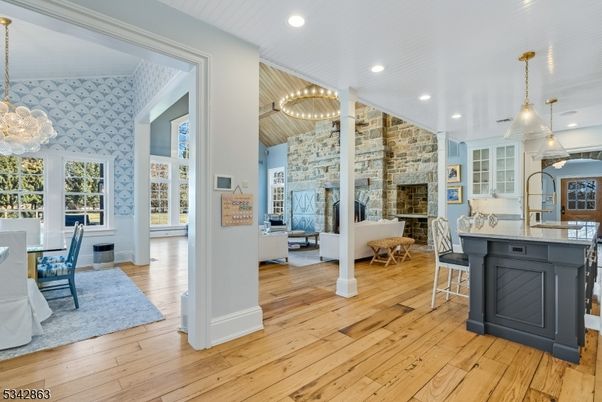 Chandelier, Dining room, Fireplace, Interior, Kitchen, Living room, Pendant Lights, Recessed Lighting, Stone Walls, Wood Texture Flooring