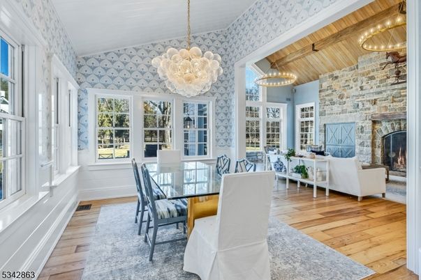 Chandelier, Dining room, Fireplace, Interior, Living room, Pendant Lights, Stone Walls, Wood Texture Flooring