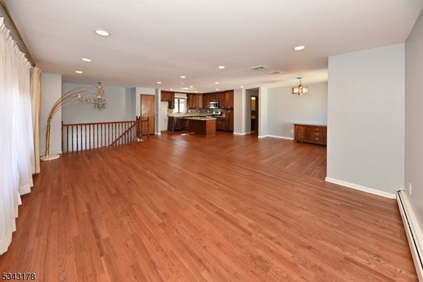 Chandelier, Empty room, Interior, Kitchen, Recessed Lighting, Stainless Steel Appliances, Wood Texture Flooring