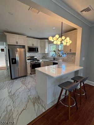 Interior, Kitchen, Marble, Pendant Lights, Recessed Lighting, Stainless Steel Appliances, Wood Texture Flooring
