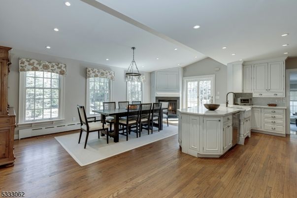 Dining room, Fireplace, Interior, Kitchen, Pendant Lights, Recessed Lighting, Stainless Steel Appliances, Wood Texture Flooring