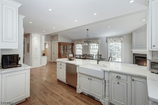 Chandelier, Dining room, Fireplace, Interior, Kitchen, Pendant Lights, Recessed Lighting, Stainless Steel Appliances, Wood Texture Flooring