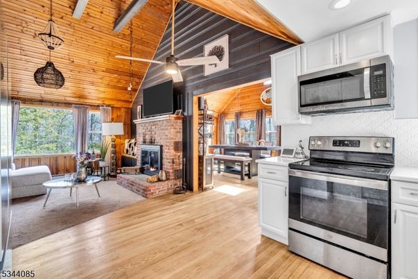 Dining room, Fireplace, Interior, Kitchen, Pendant Lights, Recessed Lighting, Stainless Steel Appliances, Stone Walls, Wooden Beams, Wooden Ceilings, Wood Texture Flooring, Wooden Walls