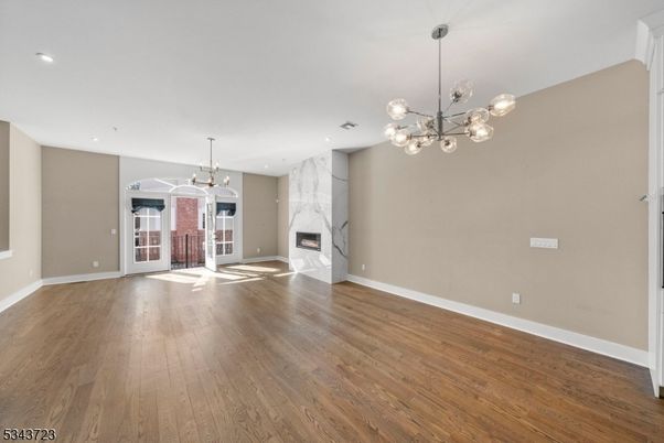 Empty room, Fireplace, Interior, Marble Walls, Pendant Lights, Recessed Lighting, Wood Texture Flooring