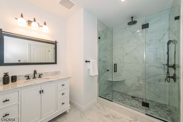 Bathroom, Dual Sink Vanities, Glass Shower, Interior, Marble, Marble Walls, Recessed Lighting