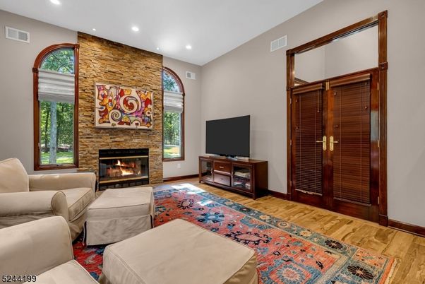 Fireplace, Interior, Living room, Recessed Lighting, Stone Walls, Wood Texture Flooring