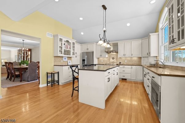 Chandelier, Dining room, Interior, Kitchen, Pendant Lights, Recessed Lighting, Stainless Steel Appliances, Wood Texture Flooring