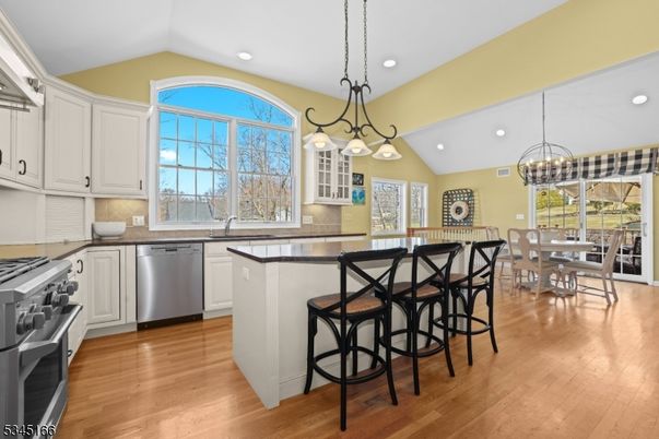 Chandelier, Dining room, Interior, Kitchen, Recessed Lighting, Stainless Steel Appliances, Wood Texture Flooring