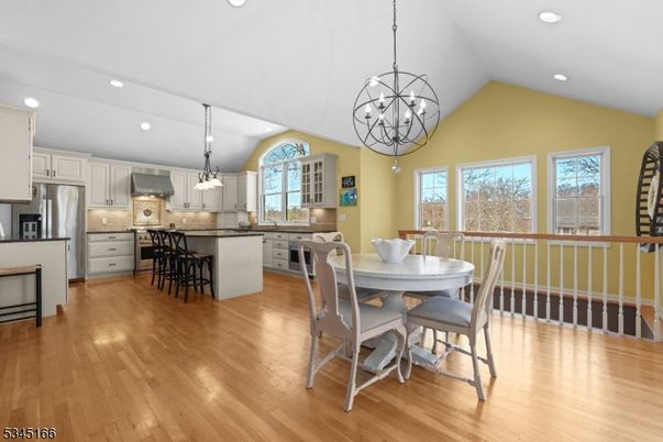 Chandelier, Dining room, Interior, Kitchen, Pendant Lights, Recessed Lighting, Stainless Steel Appliances, Wood Texture Flooring