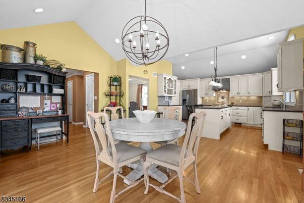 Chandelier, Dining room, Interior, Kitchen, Pendant Lights, Recessed Lighting, Stainless Steel Appliances, Wood Texture Flooring