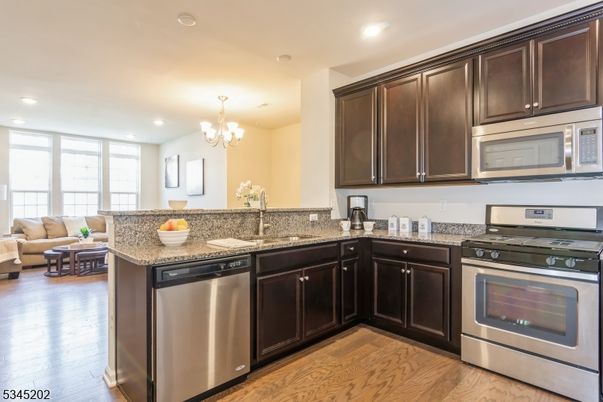Chandelier, Interior, Kitchen, Living room, Recessed Lighting, Stainless Steel Appliances, Wood Texture Flooring