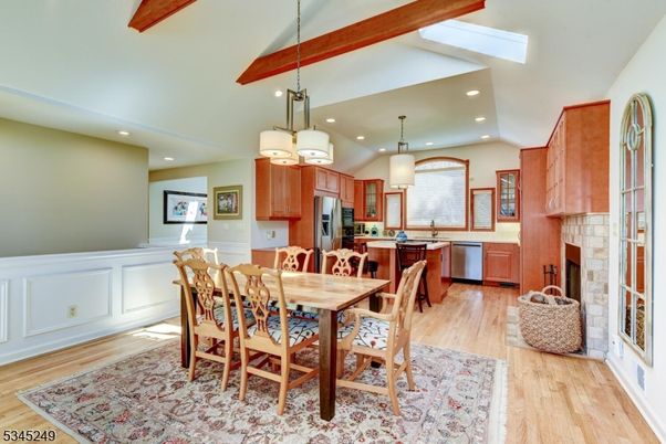 Chandelier, Dining room, Fireplace, Interior, Kitchen, Pendant Lights, Recessed Lighting, Stainless Steel Appliances, Wood Texture Flooring