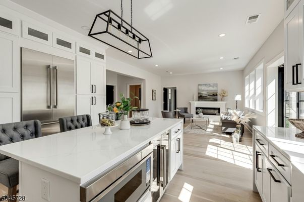 Dining room, Fireplace, Interior, Kitchen, Living room, Pendant Lights, Recessed Lighting, Stainless Steel Appliances, Wood Texture Flooring
