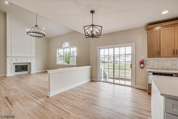 Chandelier, Empty room, Fireplace, Interior, Kitchen, Pendant Lights, Recessed Lighting, Wood Texture Flooring