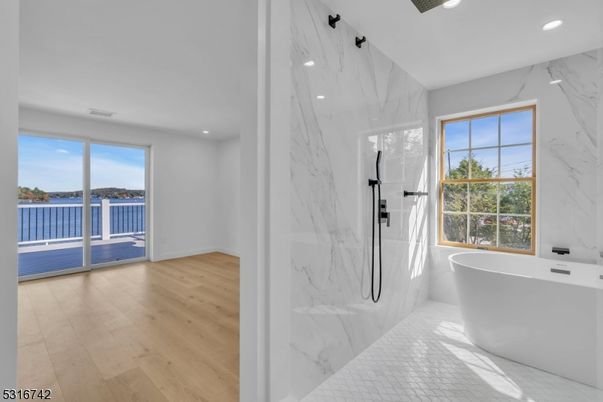 Bathroom, Free Standing Baths, Glass Shower, Interior, Marble, Marble Walls, Recessed Lighting, Wood Texture Flooring