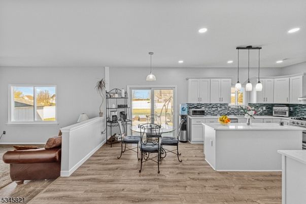 Dining room, Interior, Kitchen, Pendant Lights, Recessed Lighting, Stainless Steel Appliances, Wood Texture Flooring