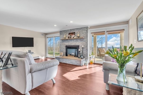 Fireplace, Interior, Living room, Recessed Lighting, Stone Walls, Wood Texture Flooring
