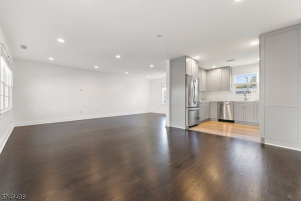 Empty room, Interior, Kitchen, Recessed Lighting, Stainless Steel Appliances, Wood Texture Flooring