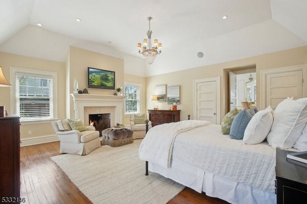 Bedroom, Chandelier, Fireplace, Interior, Recessed Lighting, Wood Texture Flooring