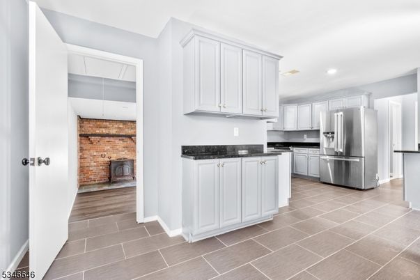 Fireplace, Interior, Kitchen, Recessed Lighting, Stainless Steel Appliances, Stone Walls, Wood Texture Flooring
