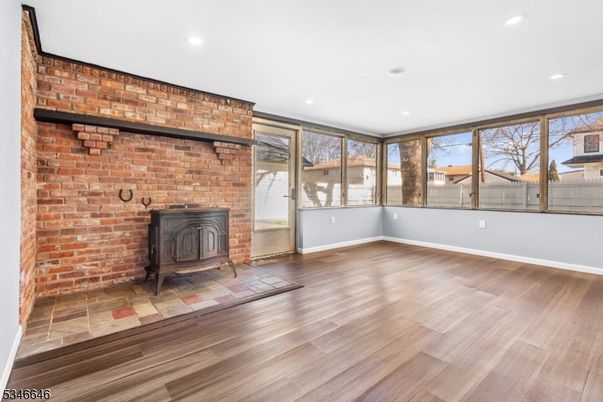 Empty room, Fireplace, Interior, Recessed Lighting, Stone Walls, Wood Texture Flooring