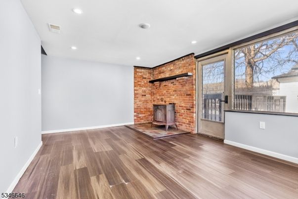 Empty room, Fireplace, Interior, Recessed Lighting, Stone Walls, Wood Texture Flooring