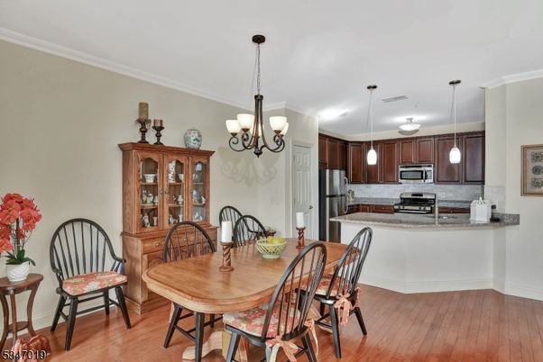 Chandelier, Dining room, Interior, Kitchen, Pendant Lights, Stainless Steel Appliances, Wood Texture Flooring