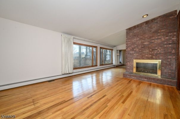 Empty room, Fireplace, Interior, Recessed Lighting, Stone Walls, Wood Texture Flooring