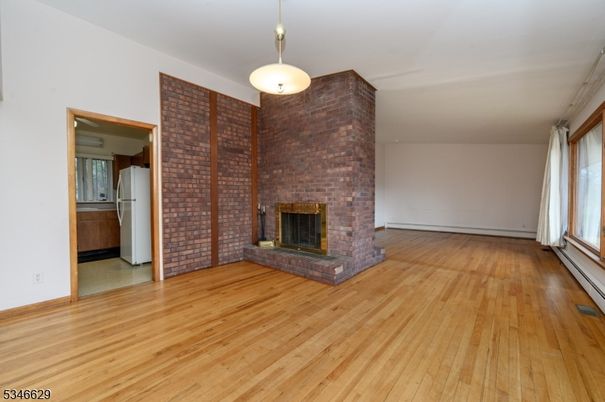 Empty room, Fireplace, Interior, Pendant Lights, Stone Walls, Wood Texture Flooring