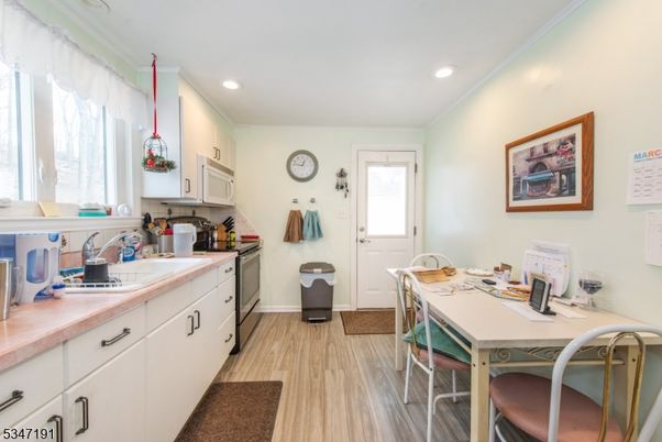 Interior, Kitchen, Pendant Lights, Recessed Lighting, Tile Countertops, Wood Texture Flooring