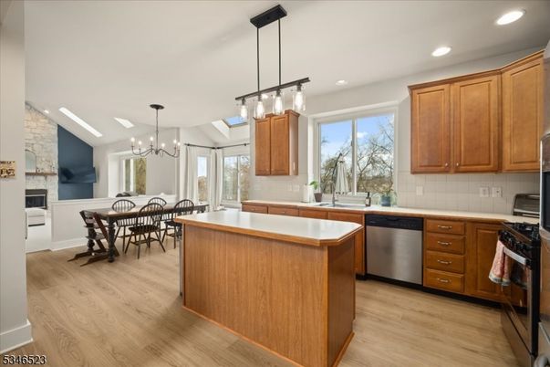 Chandelier, Dining room, Fireplace, Interior, Kitchen, Pendant Lights, Recessed Lighting, Stainless Steel Appliances, Wood Texture Flooring