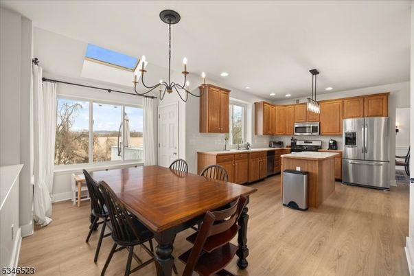 Chandelier, Dining room, Interior, Kitchen, Pendant Lights, Recessed Lighting, Stainless Steel Appliances, Wood Texture Flooring