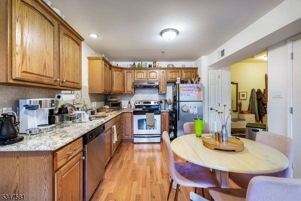Dining room, Interior, Kitchen, Recessed Lighting, Stainless Steel Appliances, Wood Texture Flooring