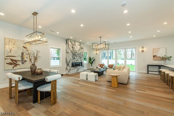 Chandelier, Dining room, Fireplace, Interior, Living room, Pendant Lights, Recessed Lighting, Wood Texture Flooring